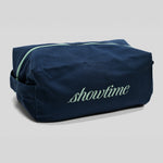 A navy blue toiletry bag with a mint green zipper and 'showtime' embroidered in mint green on the front, set against a light gray background.