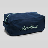 A navy blue toiletry bag with a mint green zipper and 'showtime' embroidered in mint green on the front, set against a light gray background.