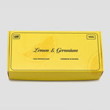 A yellow rectangular box of TIFF Lemon & Geranium cold process soap, 100g, shown on a light gray background.