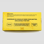 A bright yellow product box for Mind Over Matter Vegan Olive Oil Base Soap, featuring black text and product details, photographed on a light gray background.