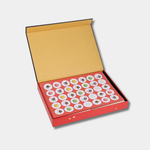 The open "Spirited Away" stationery box reveals a red interior containing a sheet of circular stickers featuring soot sprites and colorful star-shaped candy.