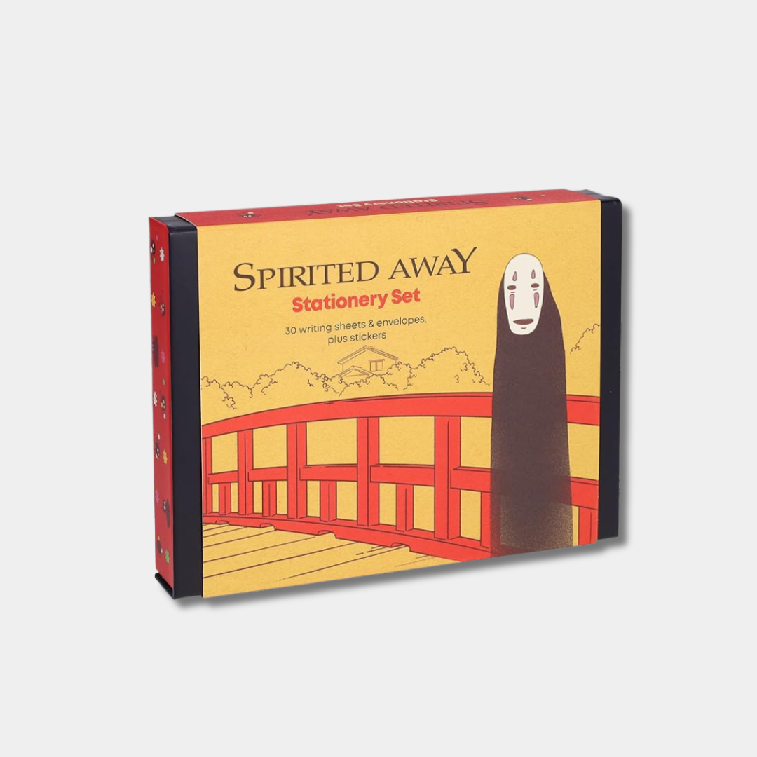The packaging for a "Spirited Away" stationery set features an illustration of No-Face standing on a red bridge against a yellow background, with the product name and contents listed in the upper left corner.