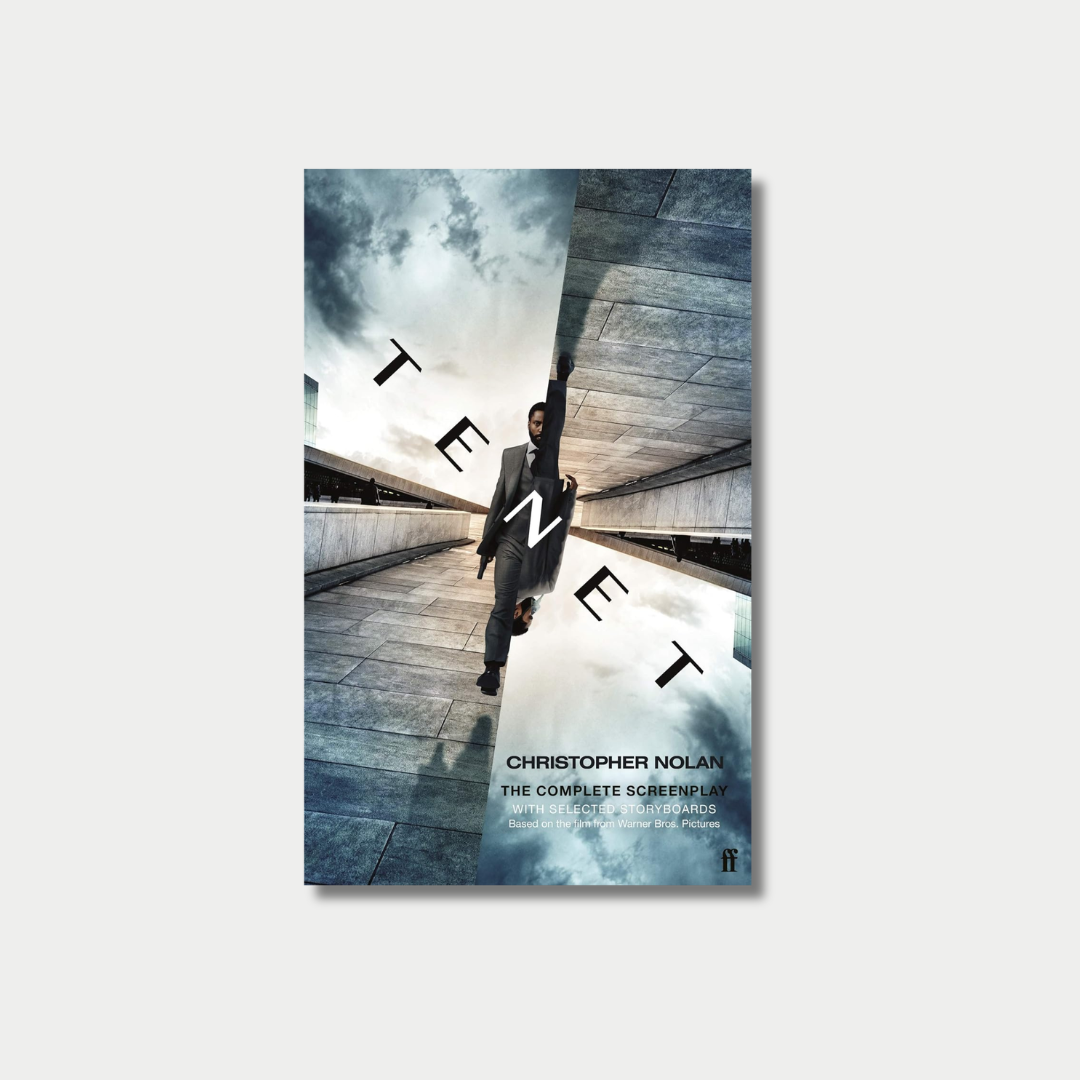 The book cover for Christopher Nolan's "Tenet: The Complete Screenplay" features a split, inverted image of a man in a suit walking along a concrete structure under a dramatic sky, with the stylized title letters oriented in opposite directions against a light gray background.