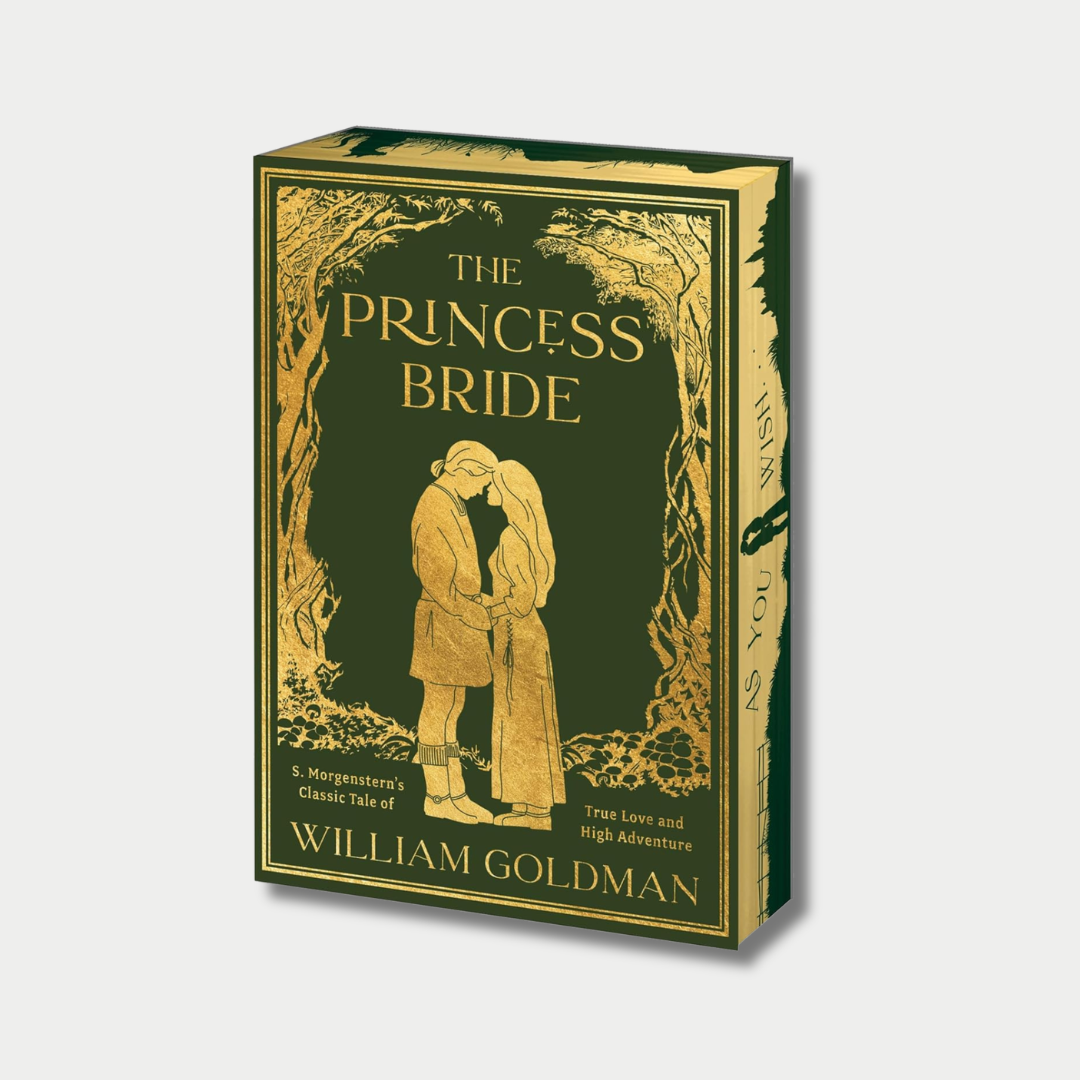 The image shows a deluxe, dark green book cover of "The Princess Bride" by William Goldman, featuring elegant gold-foiled illustrations of a forest frame, a couple embracing in the center, and the phrase "AS YOU WISH" printed along the gold-edged book pages.